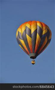 Hot air balloon rising above the horizon