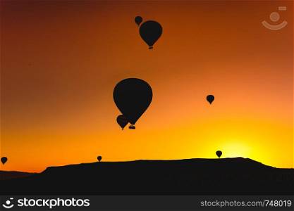 Hot air balloons floating high up in the sky in Goreme Cappadocia - Turkey Balloon Fest 2019