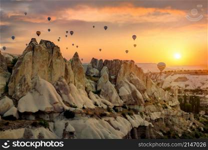 Hot air balloons over rocks in Cappadocia. Air balloons over rocks
