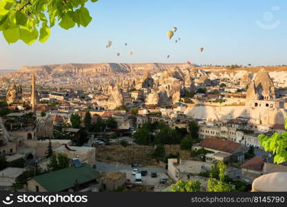 Hot air balloons over rocks in Cappadocia. Evening light in Cappadocia