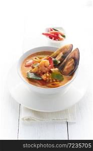 Hot and sour seafood soup on white background.. Hot and sour seafood soup.