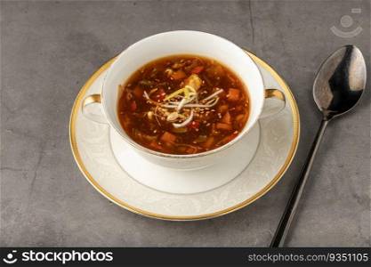 Hot and sour veggie soup on a white porcelain plate