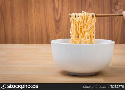 Hot and spicy lap instant noodle on wooden background