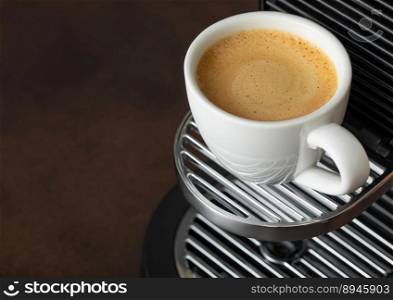 Hot aroma coffee and espresso machine on dark board.Macro