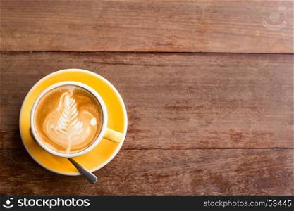 Hot art Latte Coffee in a cup on wooden table