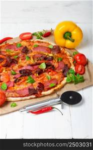 Hot baked pizza with different ingredients on wooden table