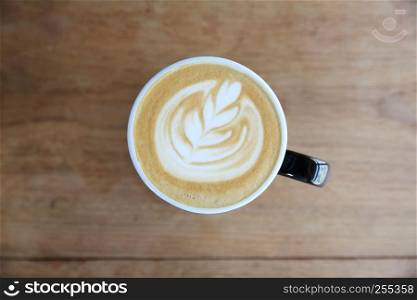 hot cappuccino coffee on wood background
