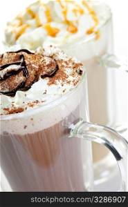 Hot chocolate and coffee latte beverages with whipped cream