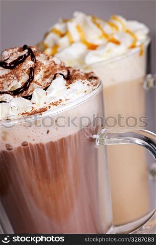 Hot chocolate and coffee latte beverages with whipped cream