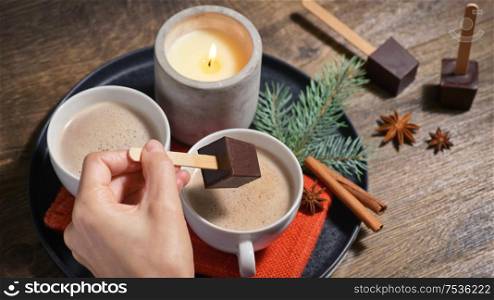Hot Chocolate With Chocolate Sticks On Wood Table