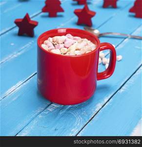 hot chocolate with marshmallow in a red ceramic mug, close up