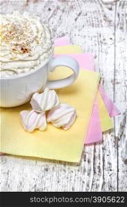hot chocolate with marshmallows and cream on wooden background