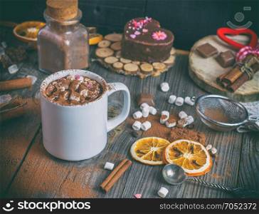 hot chocolate with marshmallows in a white mug on a gray wooden background