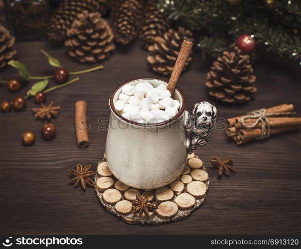 hot chocolate with white marshmallow slices in a ceramic mug on a brown wooden table, vintage toning