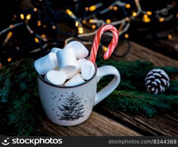 hot Christmas drink with marshmallow on wooden table