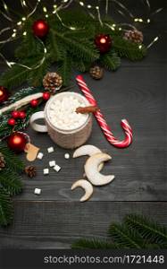 Hot cocoa drink with cinnamon stick and marshmallows with Christmas decorations on background. High quality photo. Hot cocoa drink with cinnamon stick and marshmallows with Christmas decorations on background