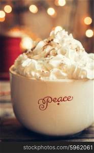 Hot cocoa in christmas mug with whipped cream on rustic wooden background