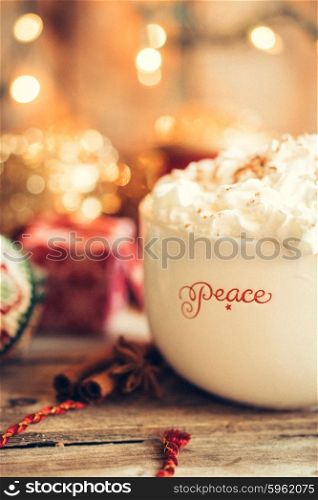 Hot cocoa in christmas mug with whipped cream on rustic wooden background