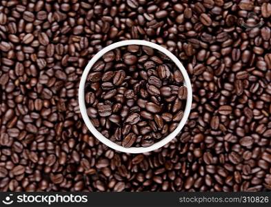 Hot coffee cup on beans for breakfast morning on wooden board