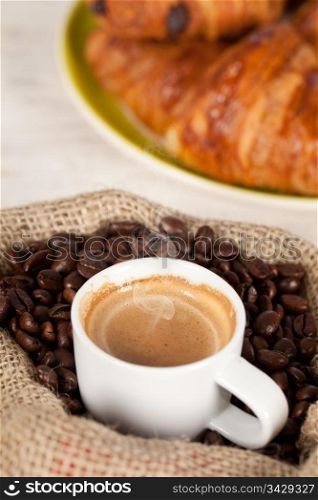 Hot coffee cup on toasted beans