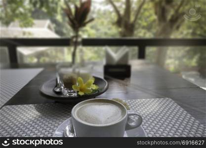 Hot coffee latte on balcony wooden table, stock photo