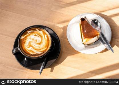 Hot coffee latte with latte art in the form of a horse milk foam in cup mug and Homemade chocolate cake on wood desk on top view. As breakfast In a coffee shop at the cafe,during business work concept