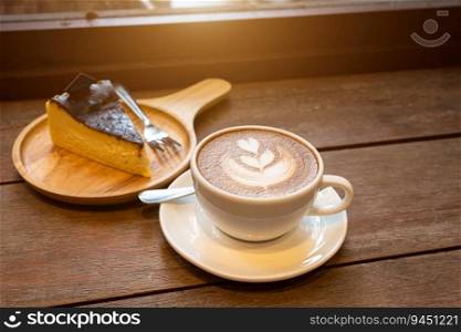 Hot coffee latte with latte art milk foam in cup mug and Homemade chocolate cake wood desk on wood desk on top view. As breakfast In a coffee shop at the cafe,during business work concept