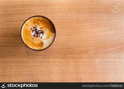 Hot Coffee Mocha on the brown wooden table with chocolate. Top view copy space