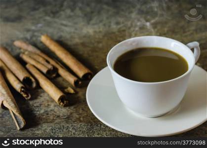 hot coffee with cinnamon sticks . hot coffee with cinnamon sticks on wooden background