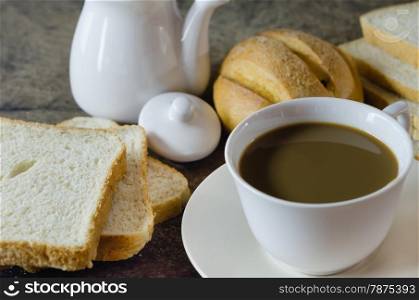 hot coffee with fresh bread on wooden background , still life