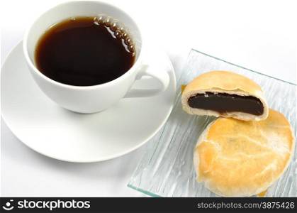 Hot coffee with sweet snack on white background