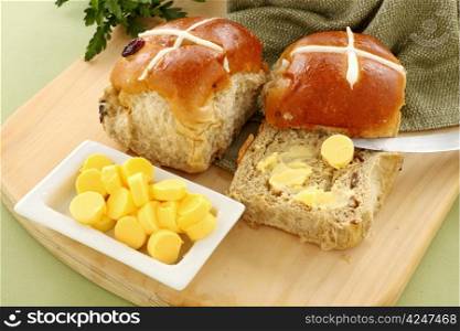 Hot cross buns with butter ready to serve for Easter.