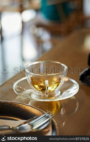 Hot cup of tea in the morning light, selective focus . Hot cup of tea in the morning light