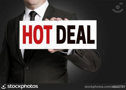Hot Deal sign is held by businessman concept. Hot Deal sign is held by businessman concept.