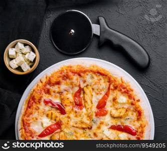 Hot delicious traditional italian pizza on a dark stone background