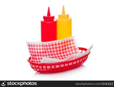 Hot dog fast food basket with ketchup and mustard and red paper on white background