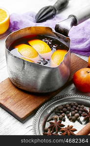 hot drink based on red wine,orange and spices in saucepan