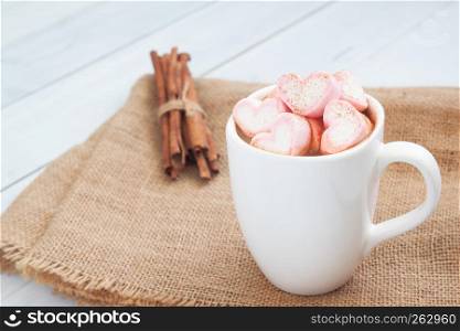 Hot drink with pink heart shape marshmallow on top. Valentine's Day concept, Cutie beverage