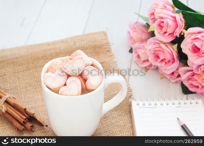 Hot drink with pink heart shape marshmallow on top. Valentine's Day concept