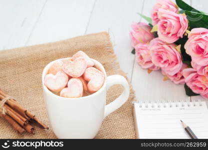 Hot drink with pink heart shape marshmallow on top. Valentine's Day concept