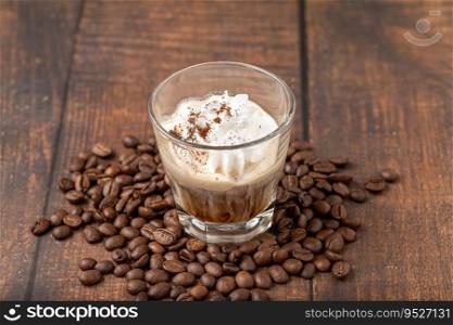 Hot espresso con panna in glass cup on wooden table