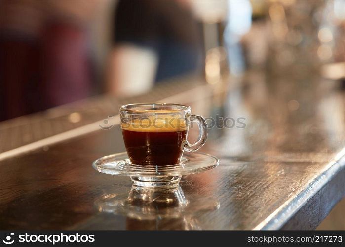 Hot espresso in a cup on the table. Cup of coffee on bar counter