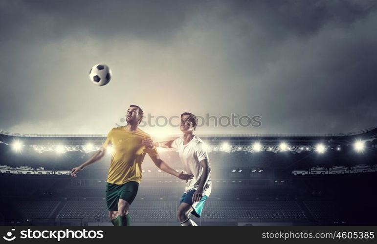 Hot football moments. Football players at stadium field fighting for ball