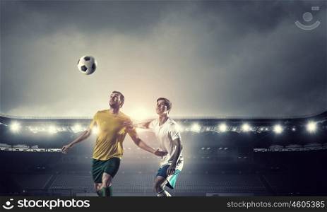 Hot football moments. Football players at stadium field fighting for ball