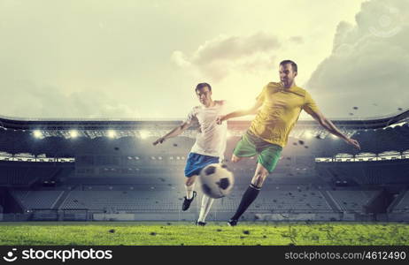 Hot football moments. Football players at stadium field fighting for ball