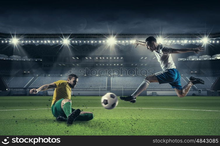 Hot football moments. Football players at stadium field fighting for ball