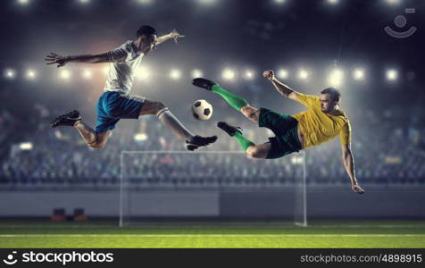 Hot football moments. Football players at stadium field fighting for ball