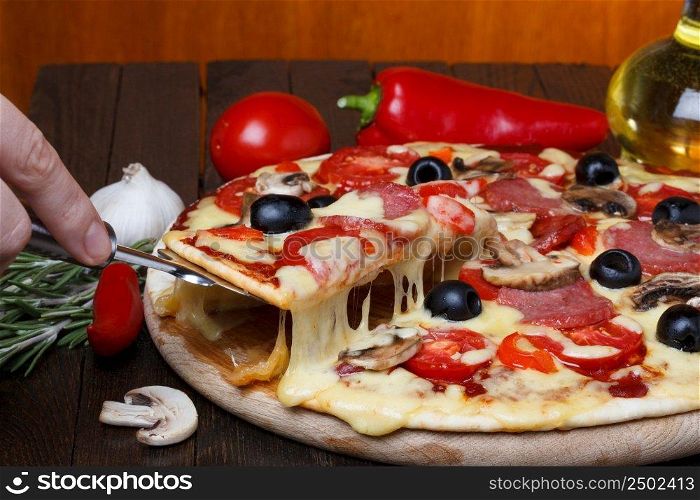 hot fresh pizza with melting cheese on lifter