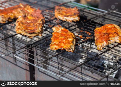 hot grill ribs barbeque on lattice above charcoal