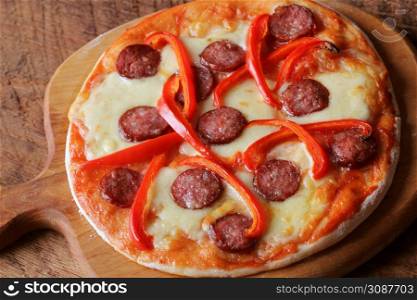 Hot homemade pizza with Pepperoni, paprica on wooden table. Top view .. Hot homemade pizza with Pepperoni, paprica on wooden table. Top view